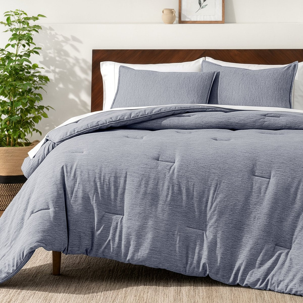 Bedding set on a bed in a bedroom with a side table and lamp.