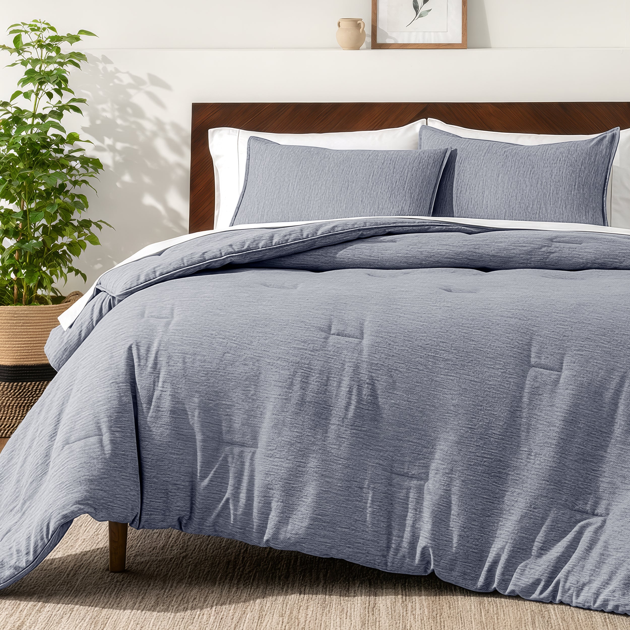 Bedding set on a bed in a bedroom with a side table and lamp.