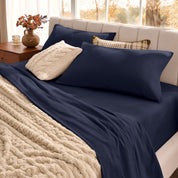 Neatly made bed with organic flannel sheets  and a beige blanket in a bright bedroom.