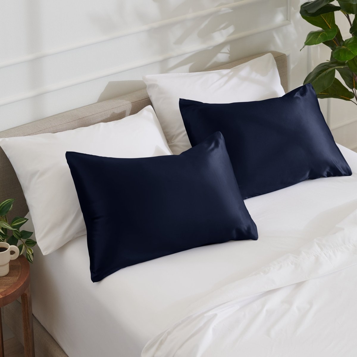 Satin pillowcases on a bed with white bedding