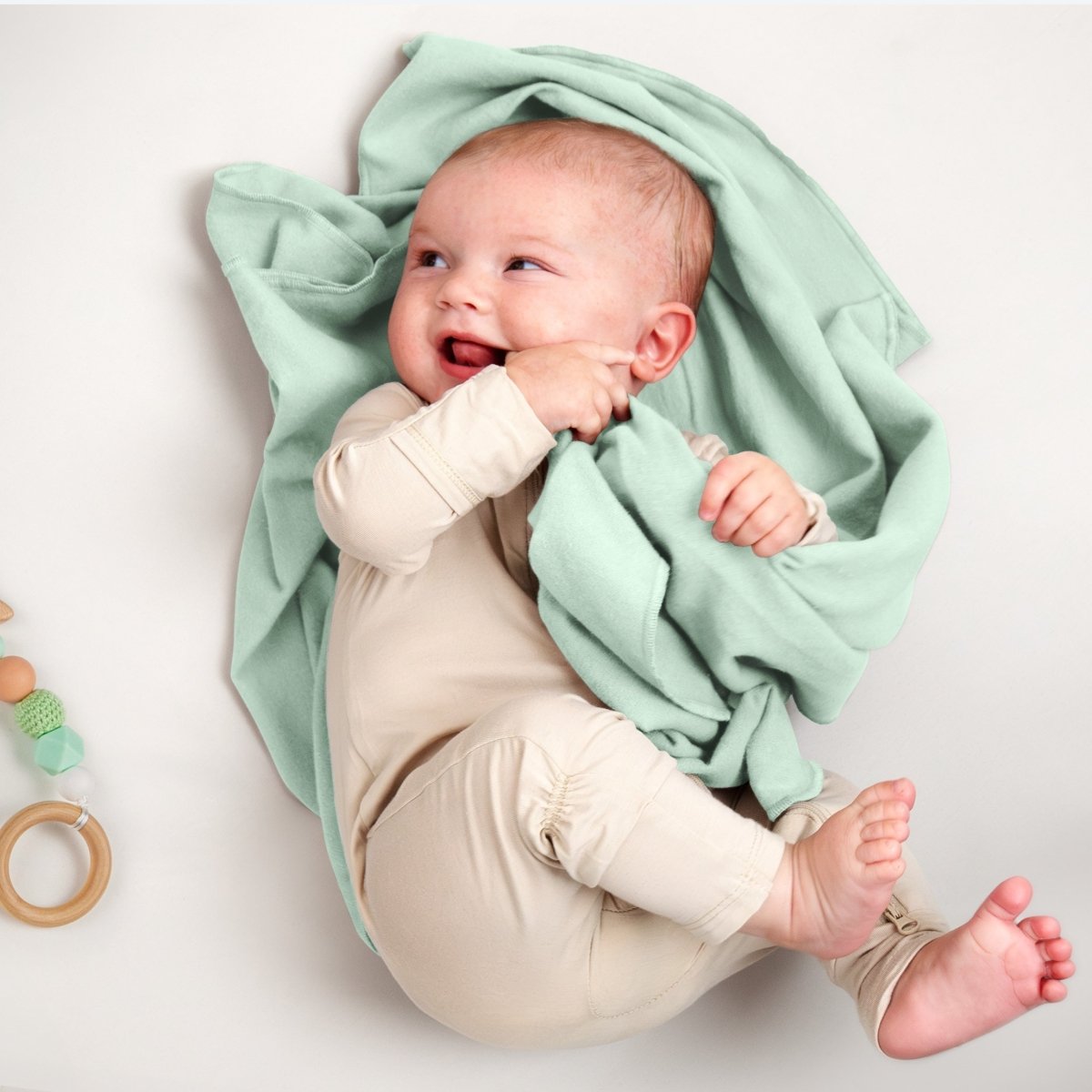 A baby lying on a flannel receiving blanket