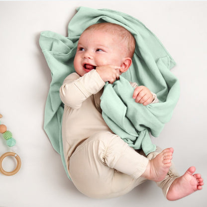 A baby lying on a flannel receiving blanket