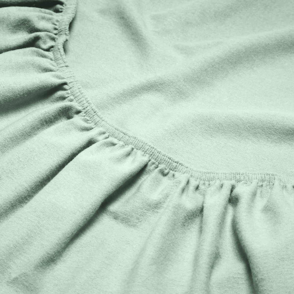 Close-up of a flannel fitted sheet with gathered elastic