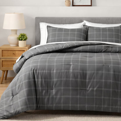 Bedding set on a bed in a bedroom with a side table and lamp.