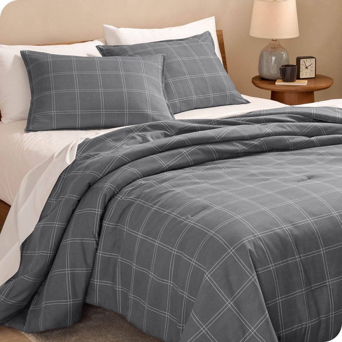 Modern plaid comforter set on a bed with white sheets
