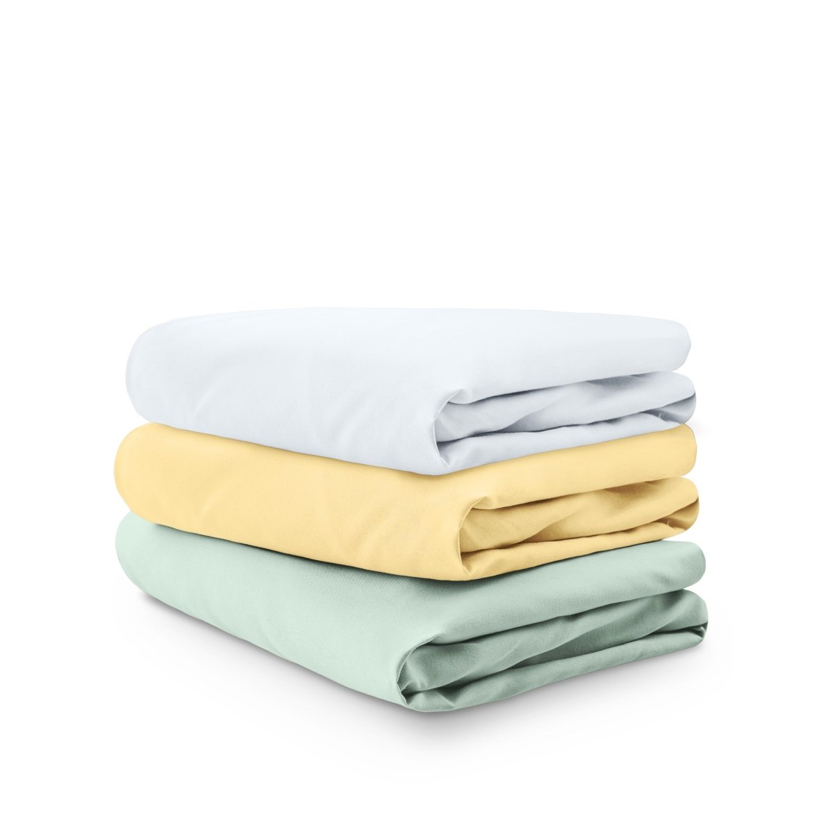 Stack of folded crib sheets on a white background