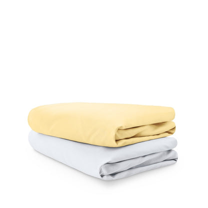 Stack of folded crib sheets on a white background