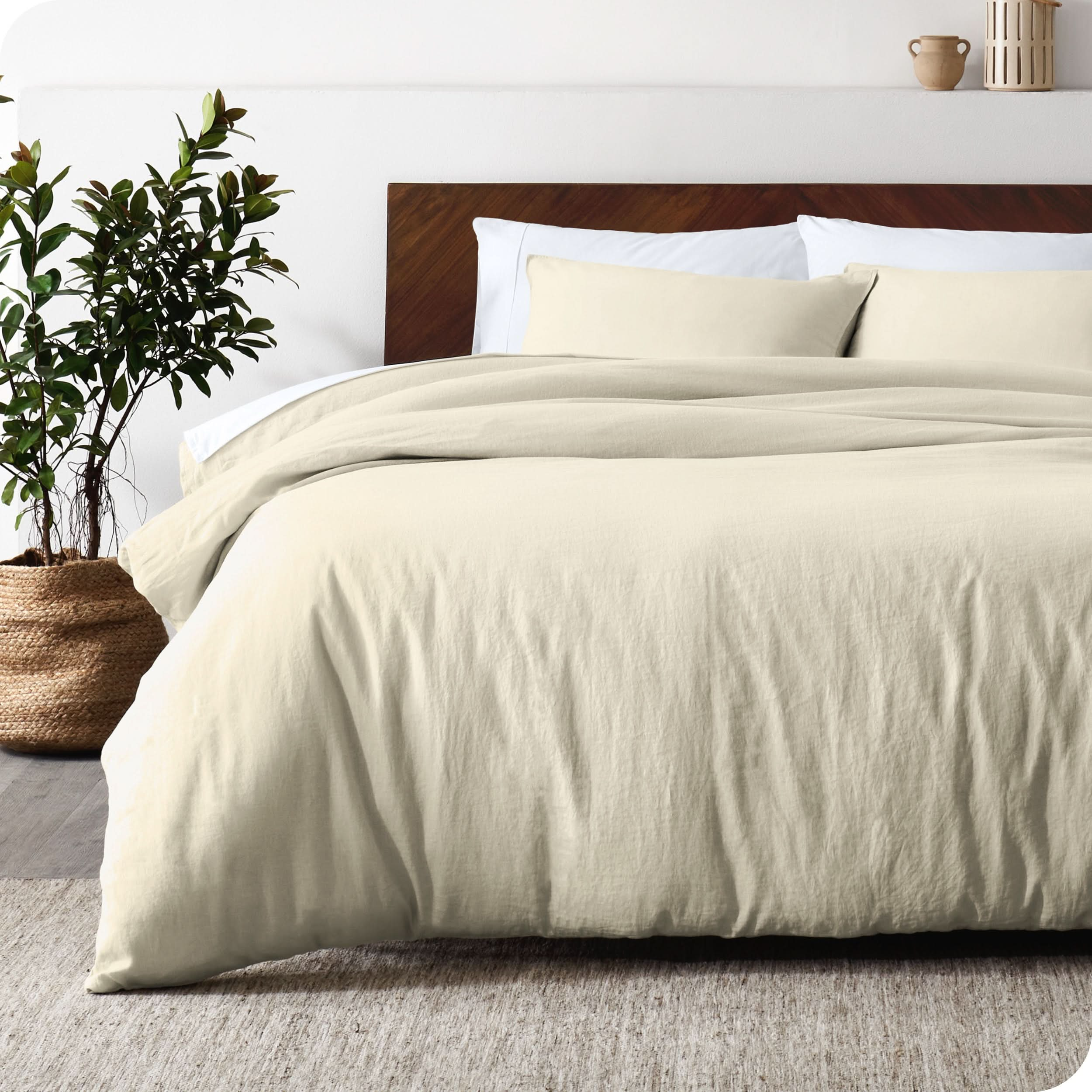 Relaxing room scene showing a natural color linen duvet cover set laid out over the bed