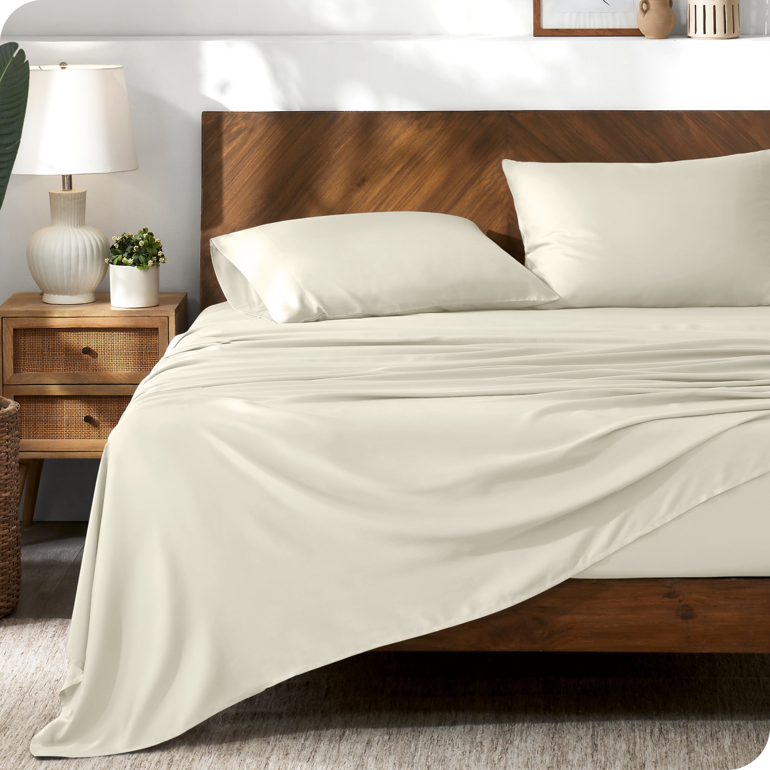 TENCEL™ sheet set on a bed. The flat sheet is draped over the side and end of the bed.
