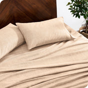 A close view of a flannel sheet set on a modern bed with two pillows.