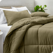 A side view of a modern bed with a comforter set and pillows on the bed