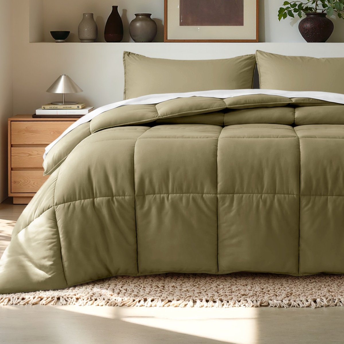 Comforter on a bed in a bedroom setting with a wooden nightstand and decorative items.