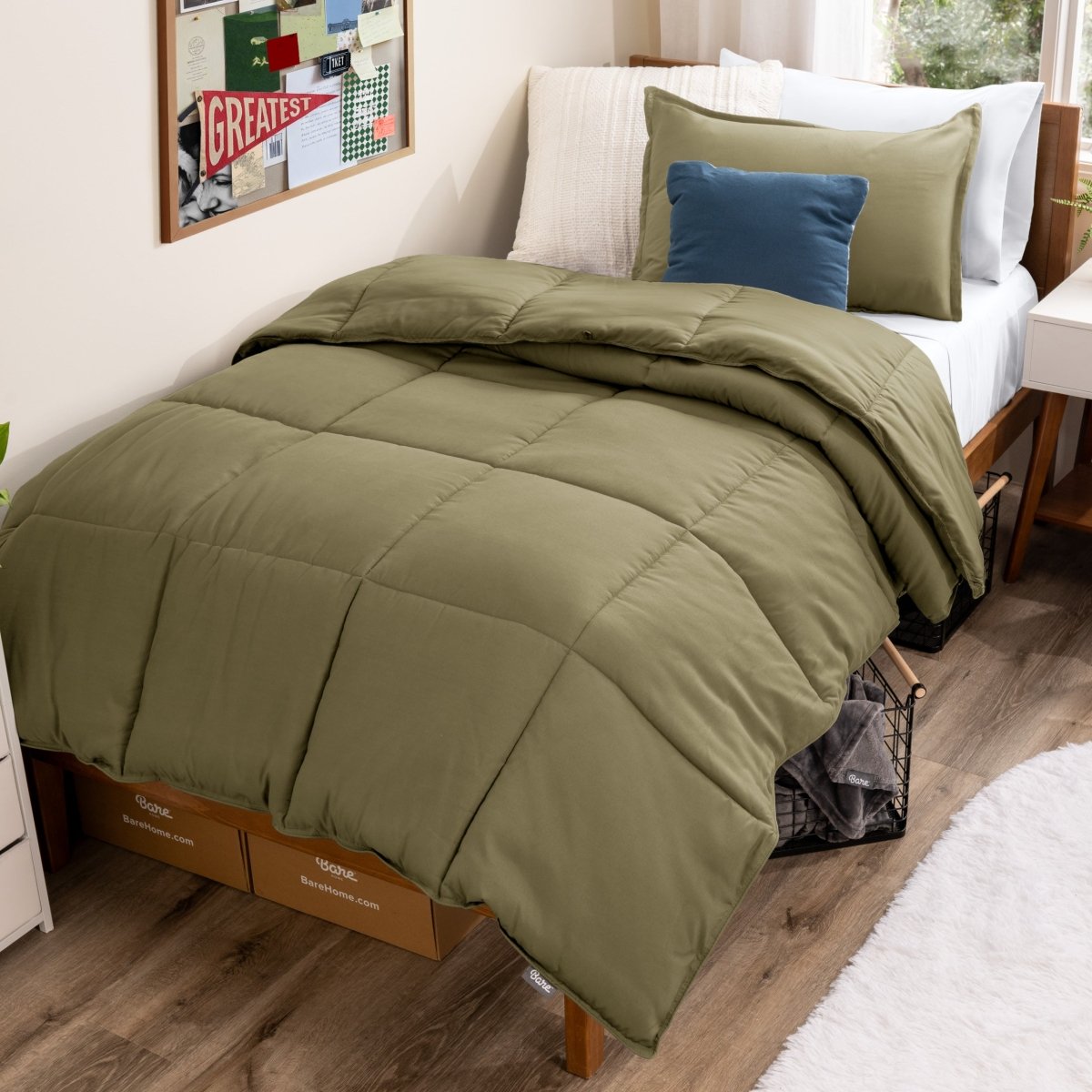Bed with comforter and pillows in a dorm room