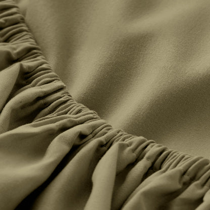Ultra soft fitted sheet on a mattress with the sun shining into the bedroom