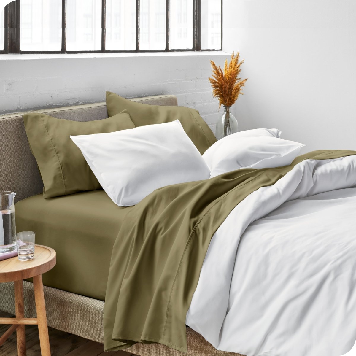 Sheets and a duvet cover on a bed in a bright bedroom