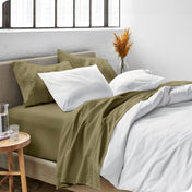 Sheets and a duvet cover on a bed in a bright bedroom