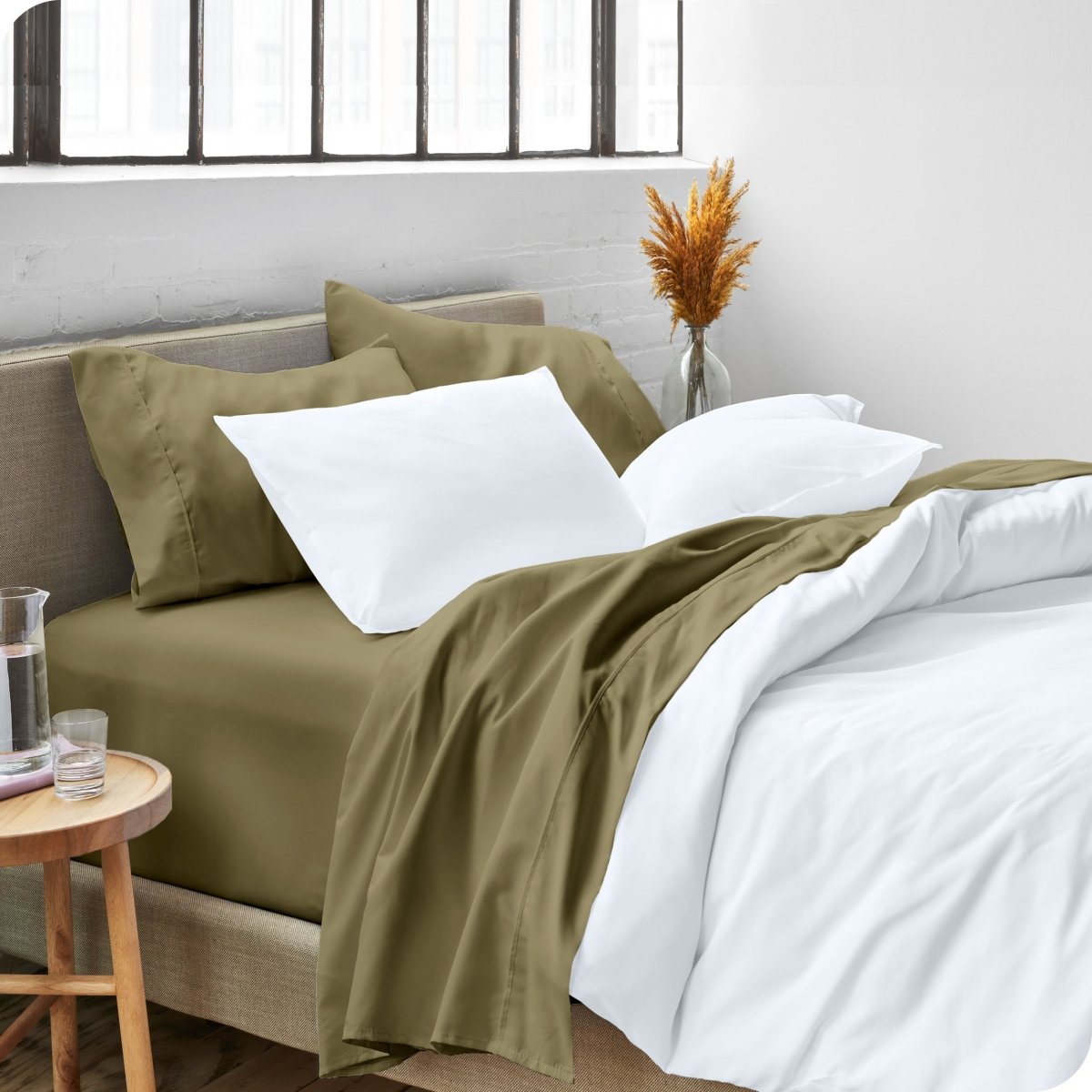 A side view of a bed made with microfiber sheets and a white duvet cover