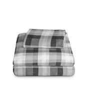 Stack of flannel sheets and pillowcases on a white background