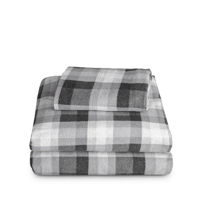 Stack of flannel sheets and pillowcases on a white background