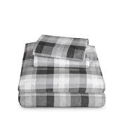 Stack of flannel sheets and pillowcases on a white background