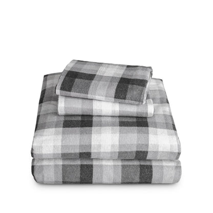 Stack of flannel sheets and pillowcases on a white background