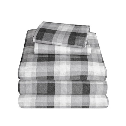 Stack of flannel sheets and pillowcases on a white background