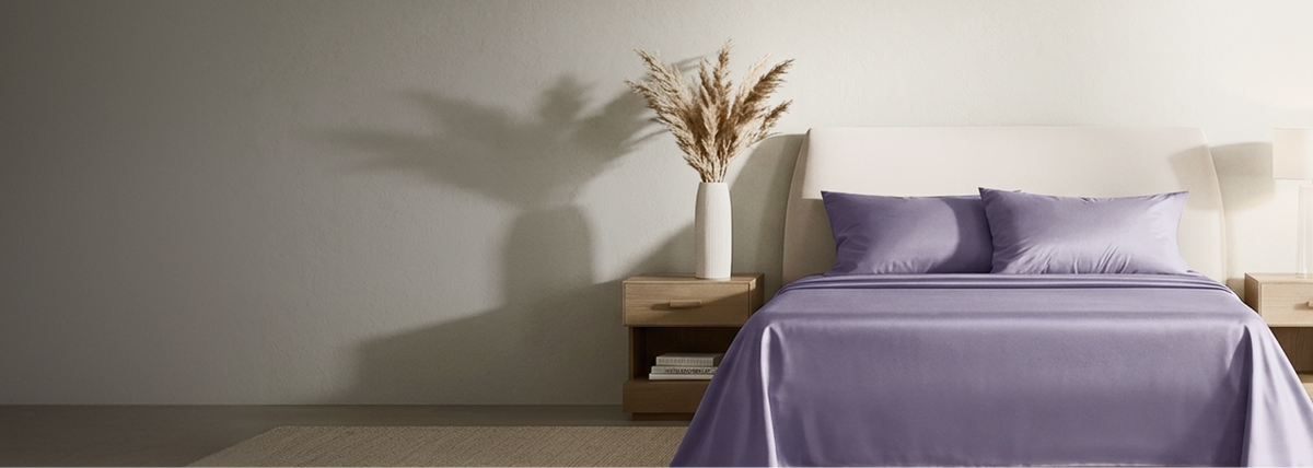 A bed made with purple sheets