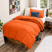 Comforter set on a bed in a bedroom with a window and decor.