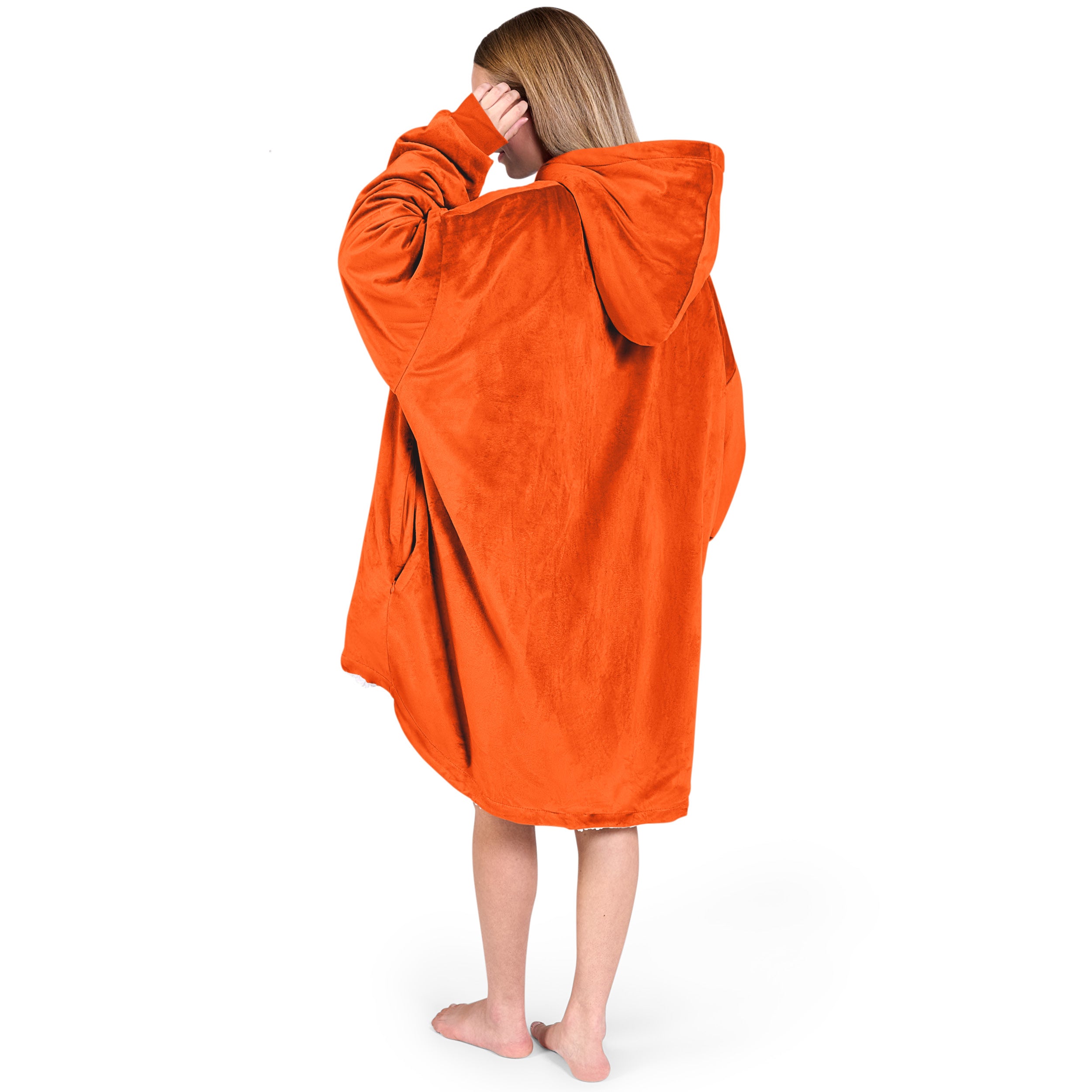 An adult with a hooded wearable blanket on