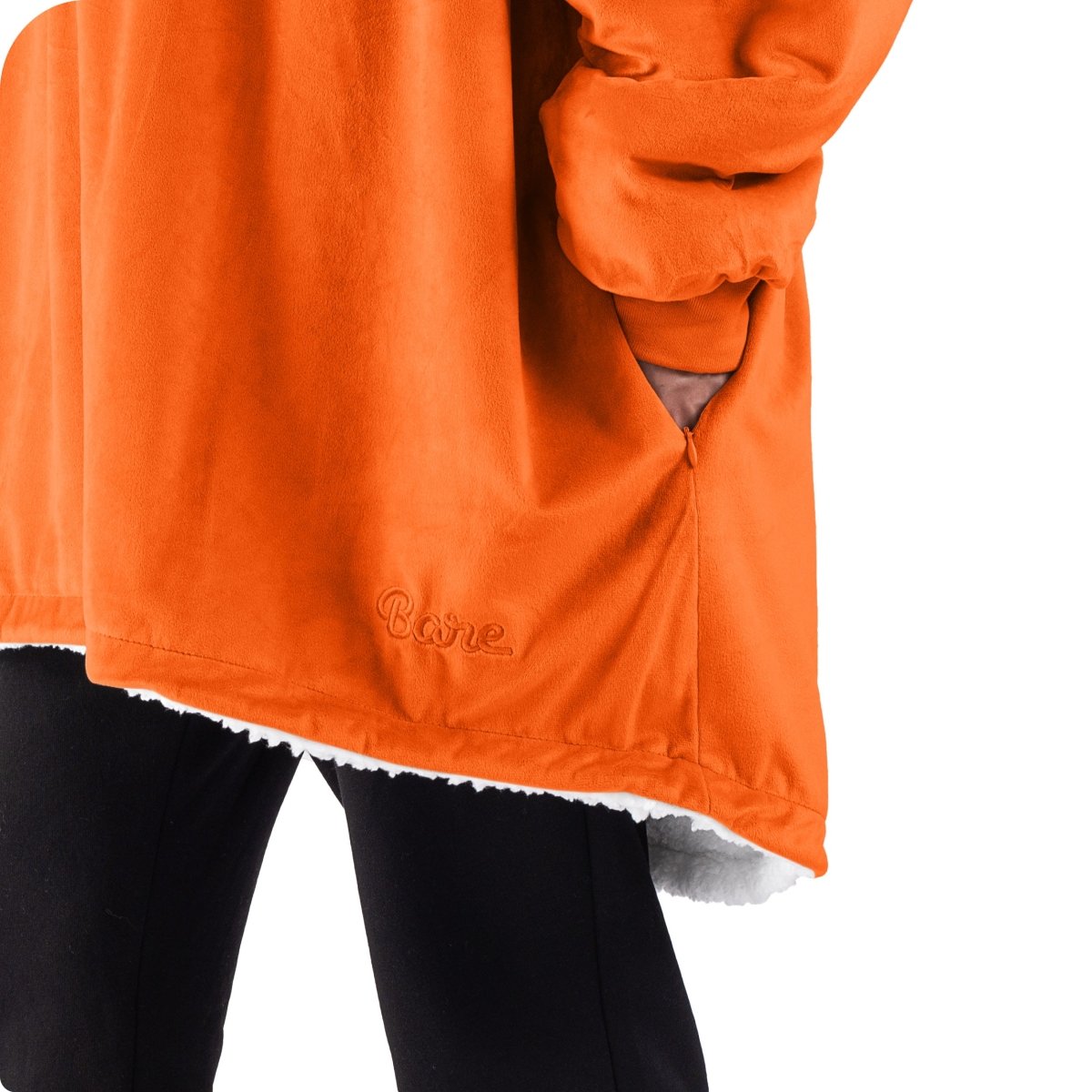 An adult with a sherpa wearable blanket on