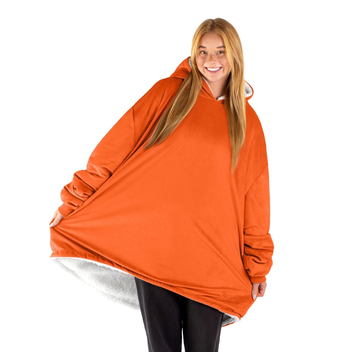 An adult with a sherpa wearable blanket on