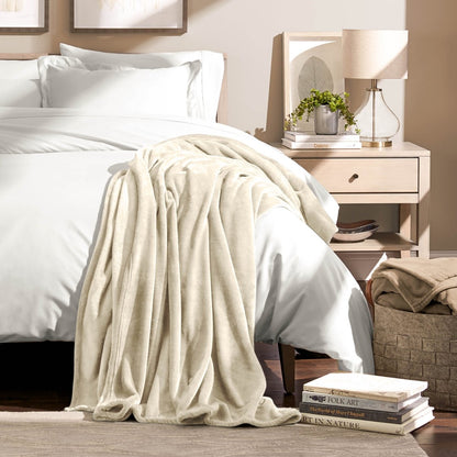 A microplush blanket draped over the corner of a bed