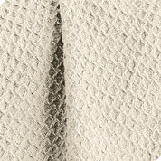 Close up of the fabric of a cotton waffle blanket