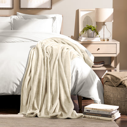 Microplush blanket draped over the corner of a bed