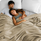 A couple sleeping with covered with a giant microplush blanket