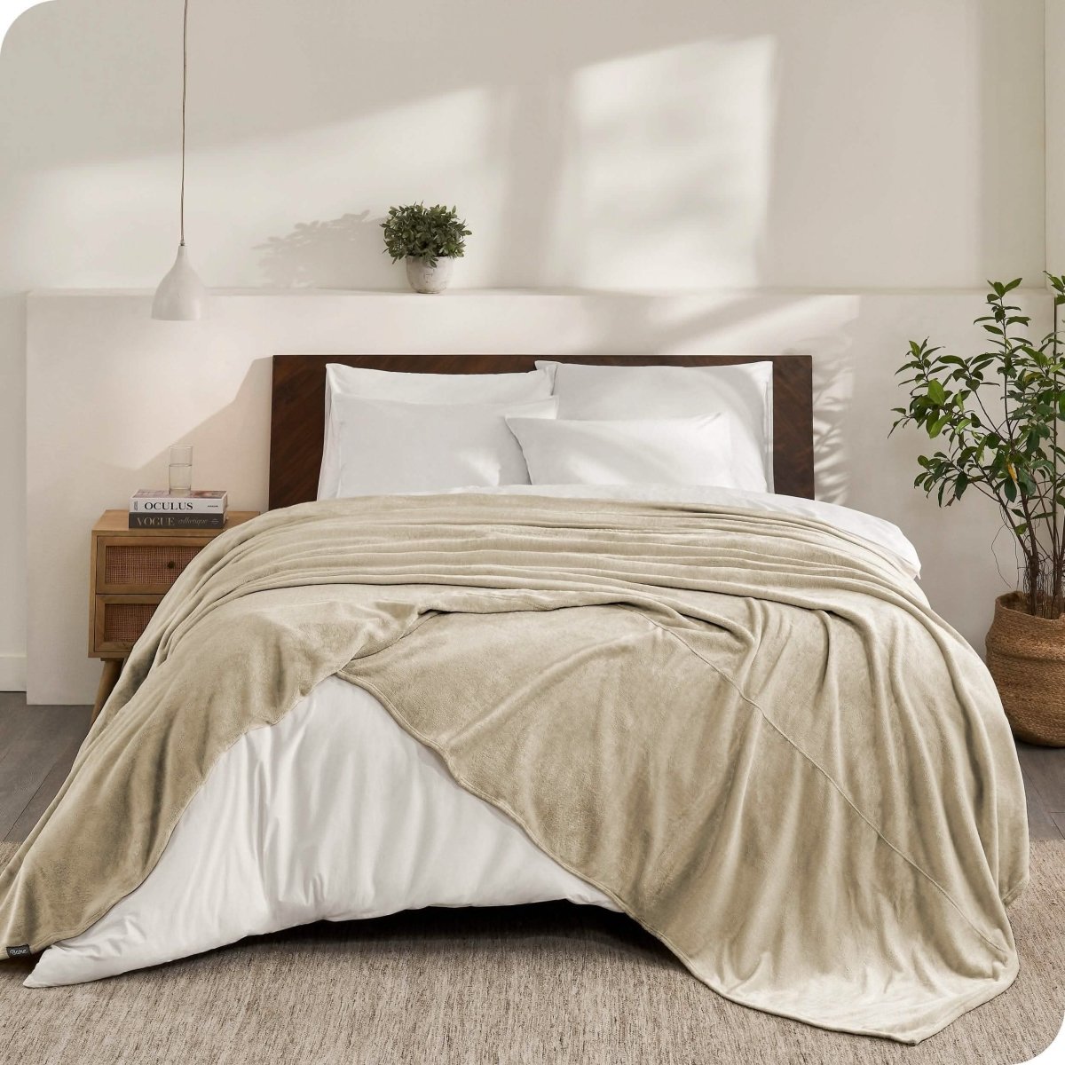 An oversized microplush blanket draped over a bed
