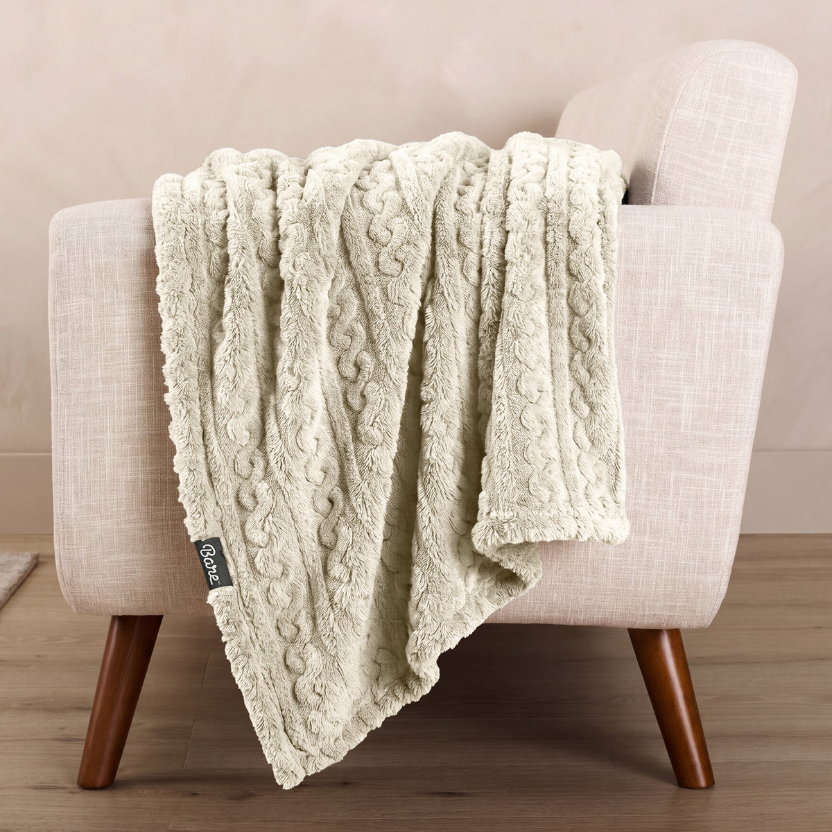 A textured blanket draped over a chair