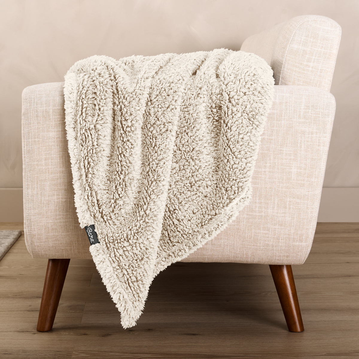 A textured blanket draped over a chair