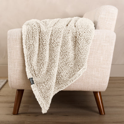 A textured blanket draped over a chair