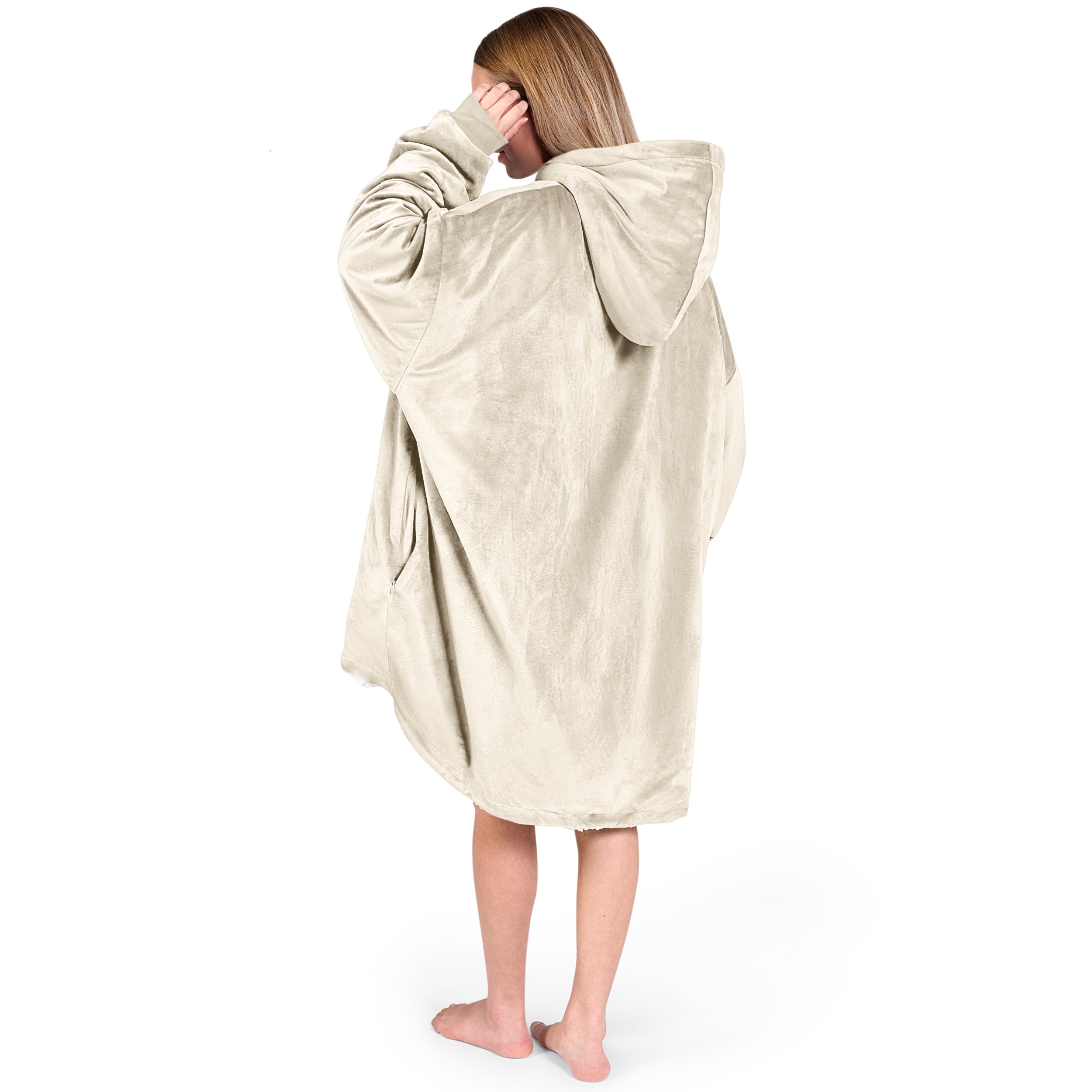 An adult with a hooded wearable blanket on