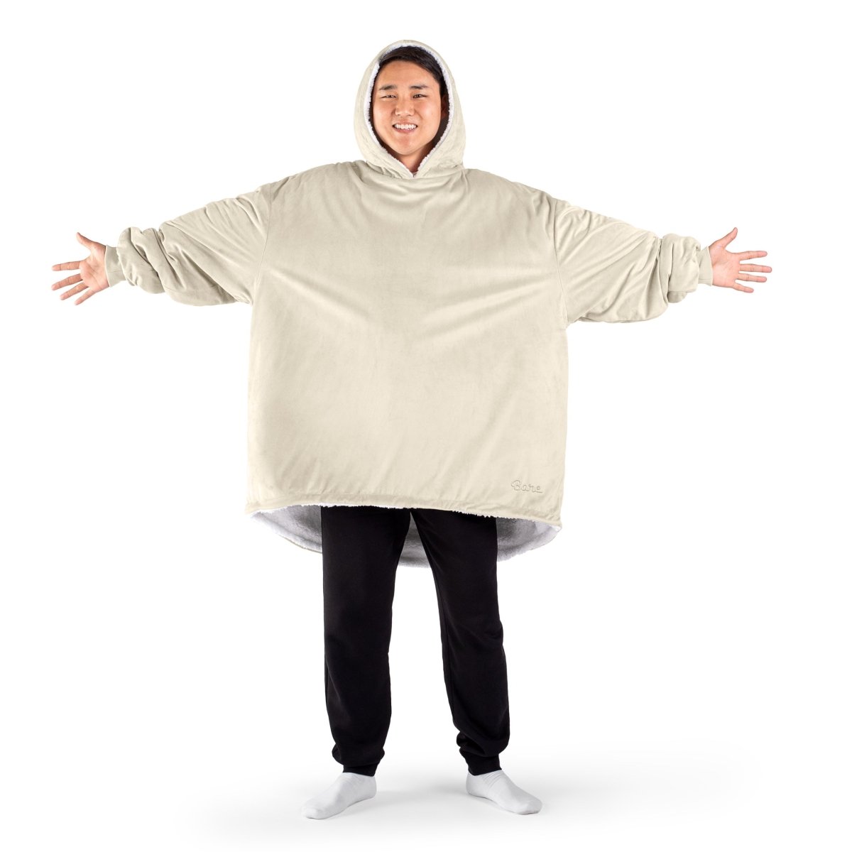 An adult with a sherpa wearable blanket on