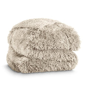 A shaggy faux fur blanket folded