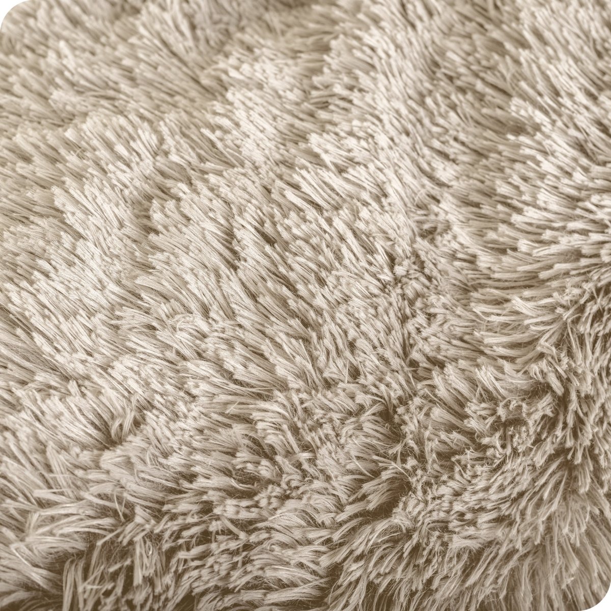 A shaggy faux fur blanket draped over the arm of a chair