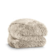 A shaggy faux fur blanket folded