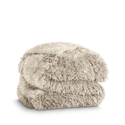 A shaggy faux fur blanket folded