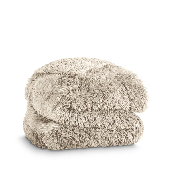 A shaggy faux fur blanket folded