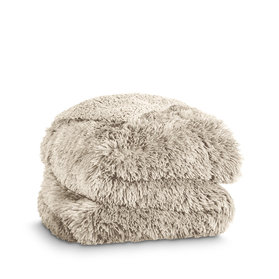 A shaggy faux fur blanket folded