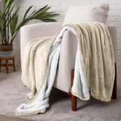 Blanket draped over a chair in a cozy living room setting.