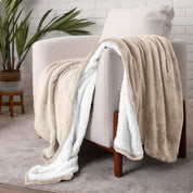 Blanket draped over a chair in a cozy living room setting.