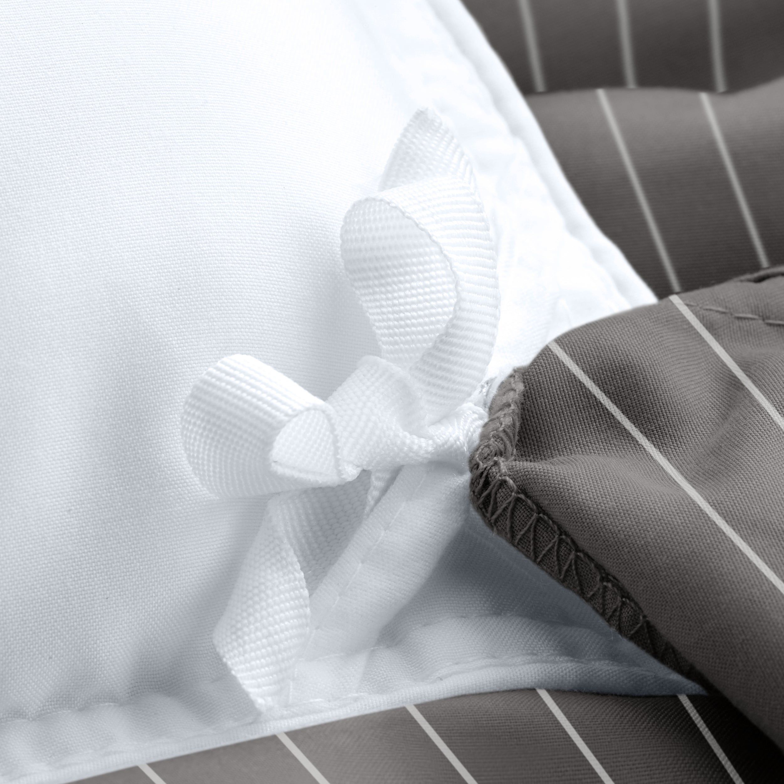 Close-up of a pinstripe duvet cover with corner ties